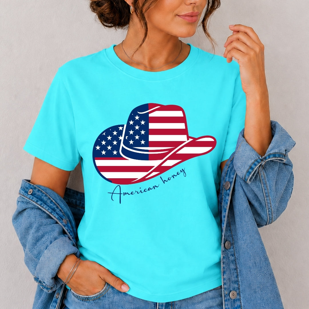 Person wearing a turquoise t-shirt with an American flag cowboy hat design and 'American honey' text.