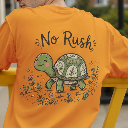 Back view of a person wearing an orange t-shirt showcasing the smiling "No Rush" turtle design