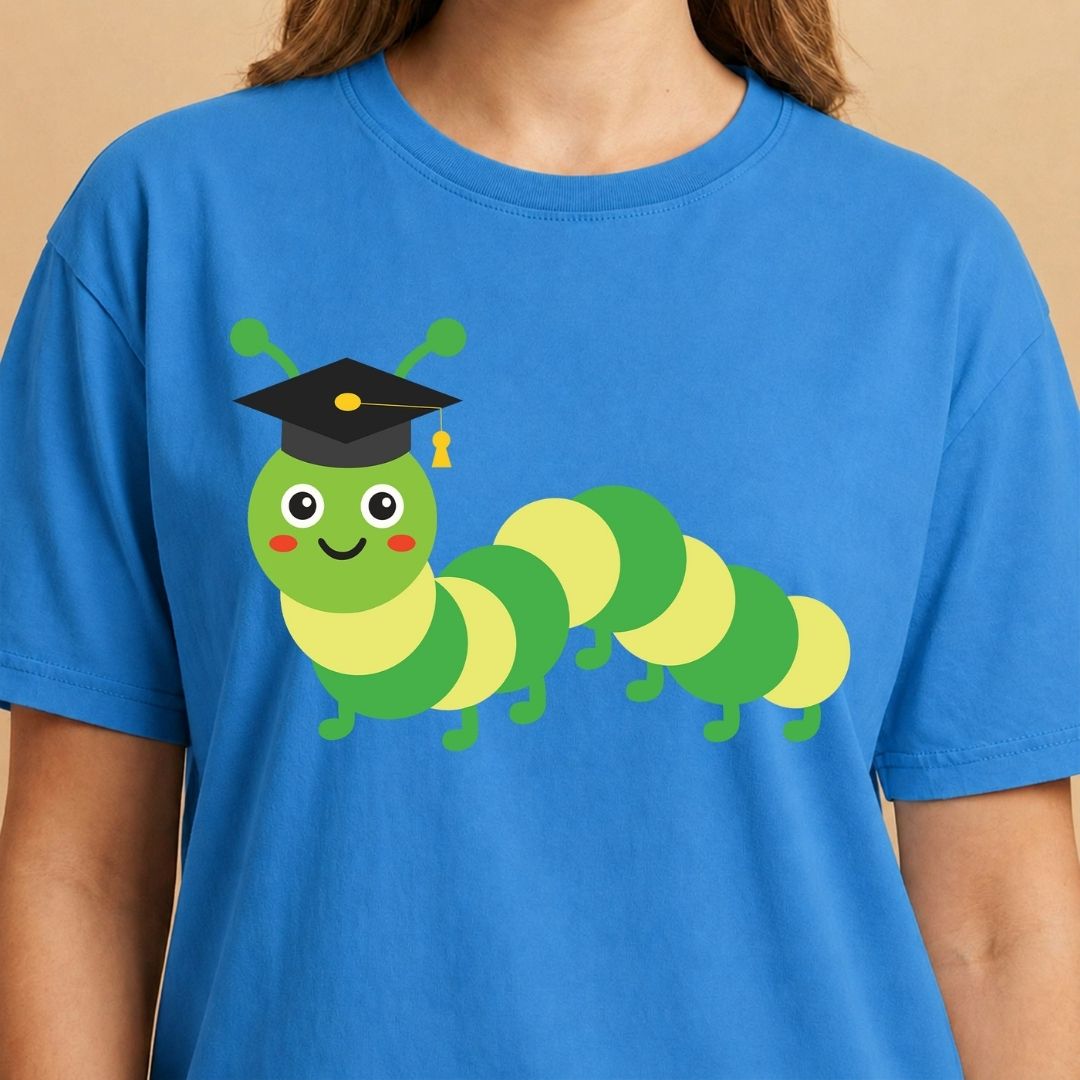 Blue t-shirt with a green caterpillar wearing a graduation cap on a beige background