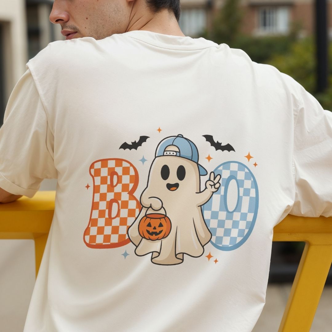 Back view of a person wearing an off-white t-shirt featuring a vibrant cute Halloween ghost and checkered text design.