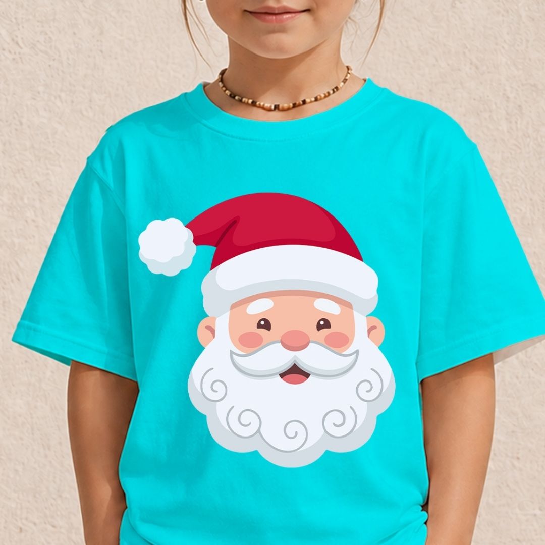 A child wearing a bright turquoise short-sleeve T-shirt with a large cartoon Santa Claus face graphic on the front, including a red hat, white beard, and pink cheeks, against a light beige textured wall.