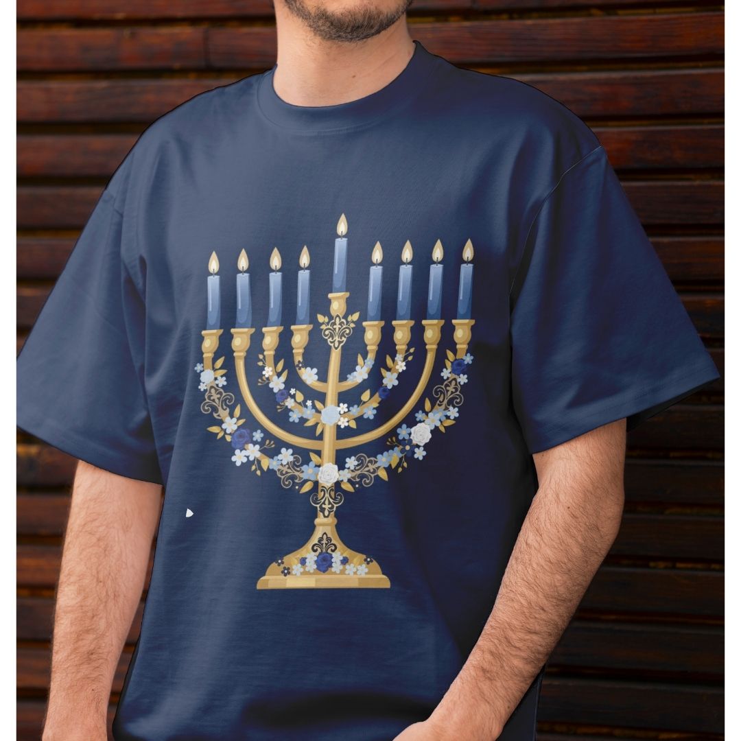 A man wearing a navy blue t-shirt with a large gold and blue menorah graphic on the front, set against a dark wooden plank background.