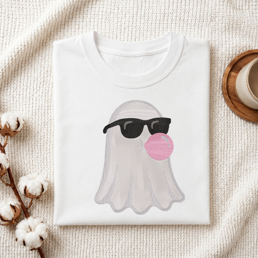 Cool ghost with bubblegum embroidery stitched onto a folded white t-shirt.