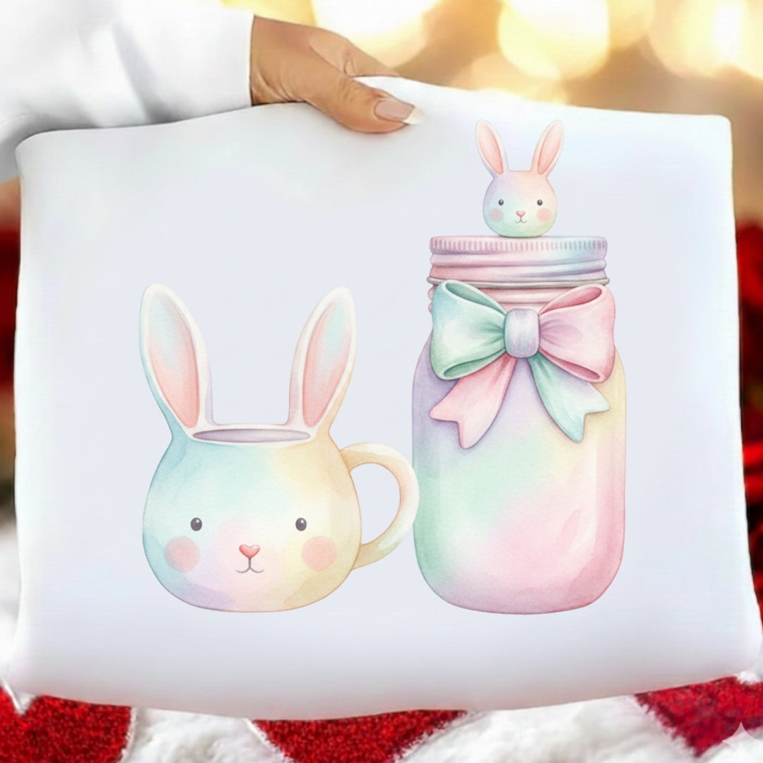 Decorative pillow with pastel-colored bunny mug and jar design on a white background.