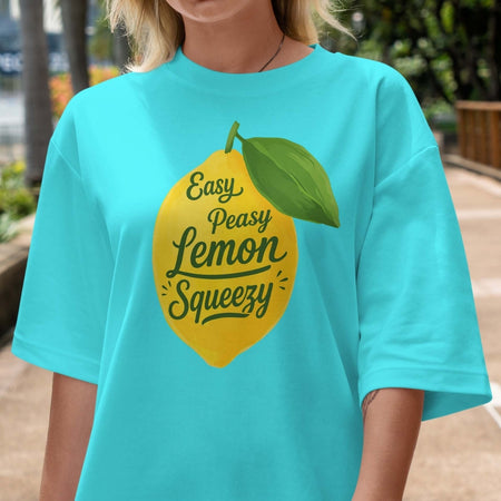 Person wearing a turquoise t-shirt with a lemon graphic and text.