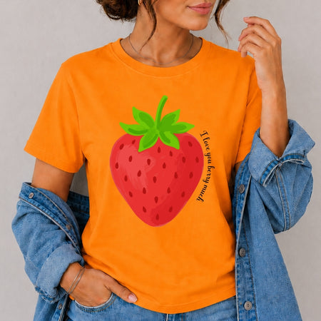 Person wearing an orange t-shirt with a strawberry graphic and text.