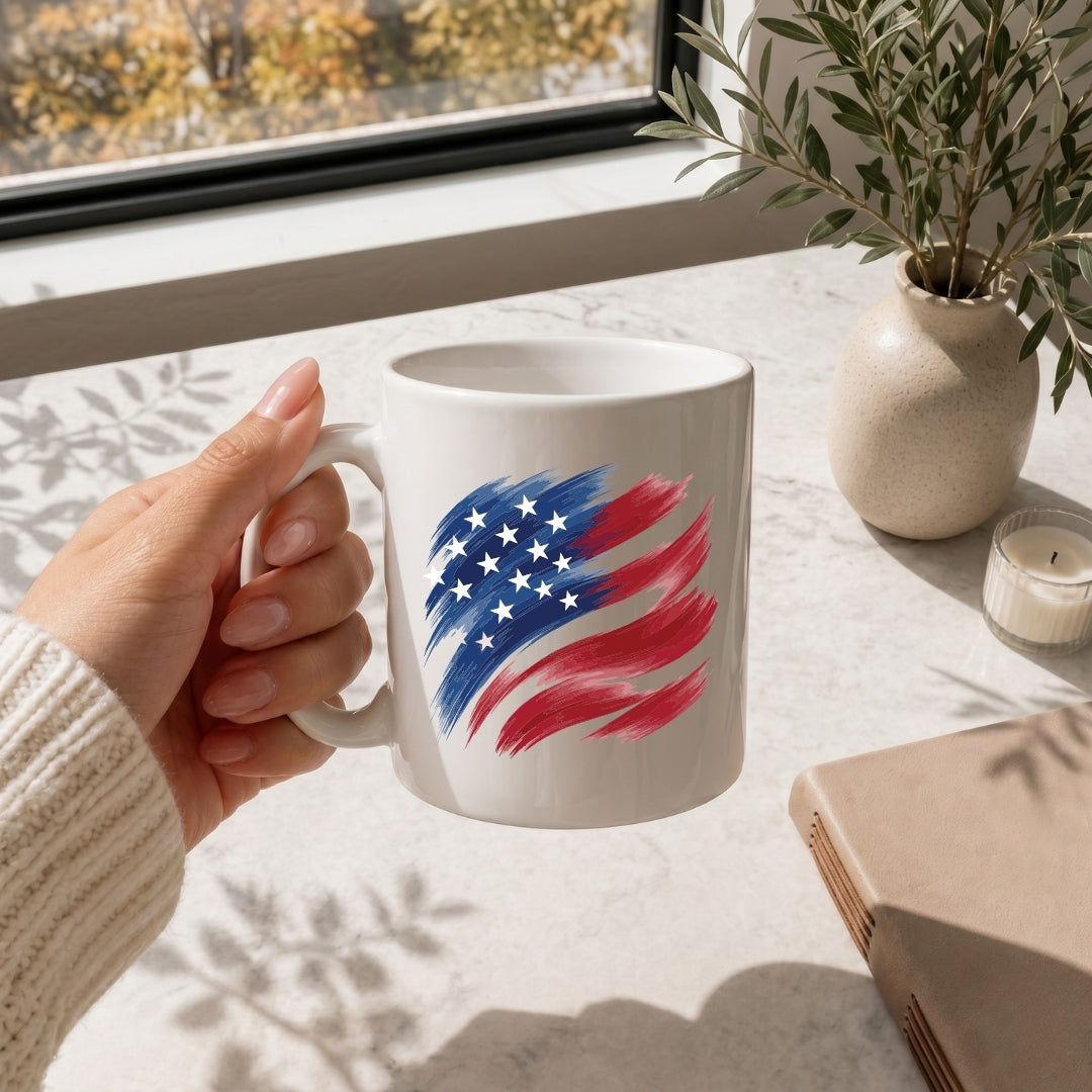 A woman holding a white ceramic mug featuring a stylized brushstroke American flag graphic.