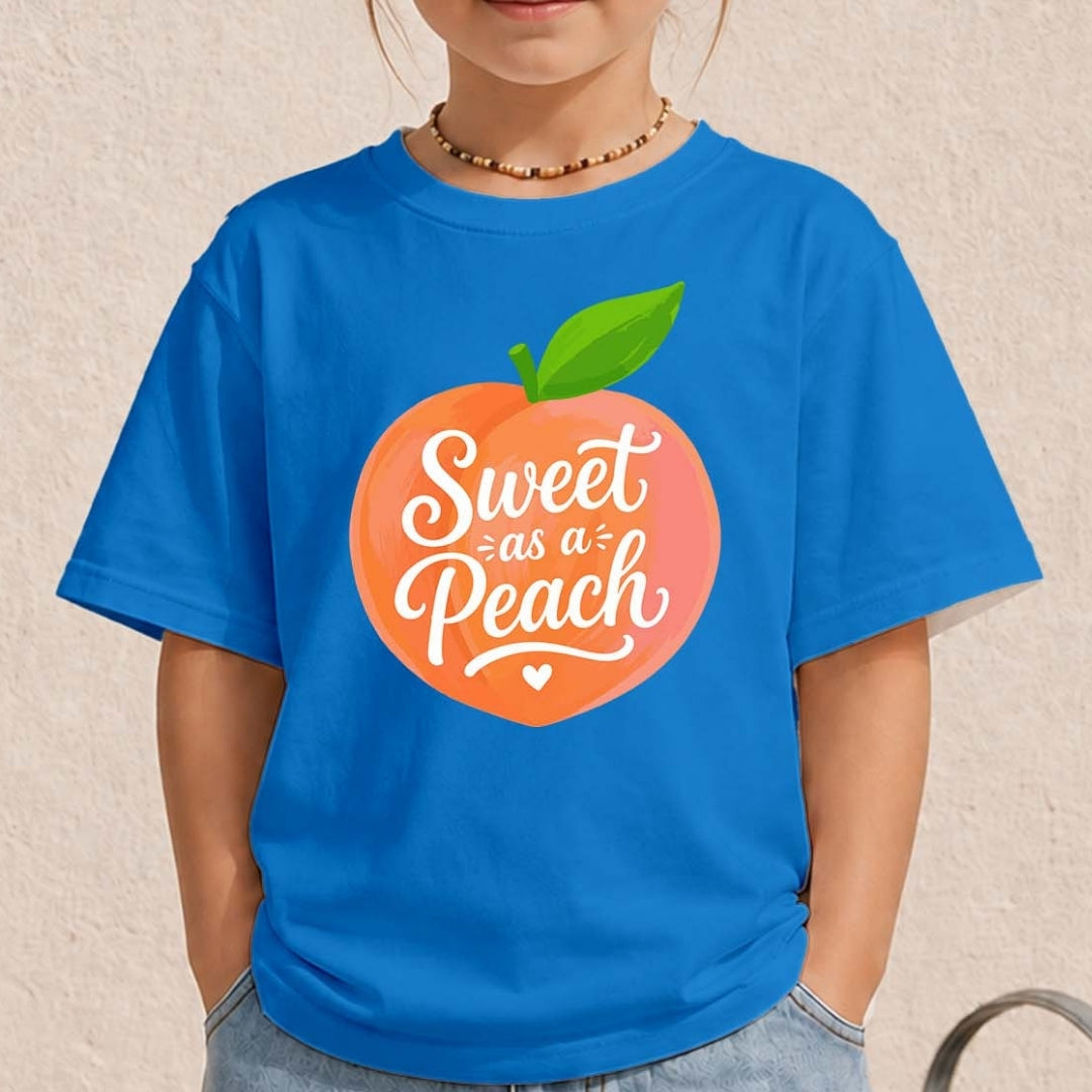Child wearing a blue t-shirt with a peach graphic and text on a beige background