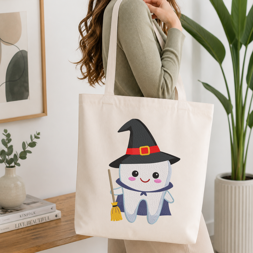 Woman carrying a white natural canvas tote bag featuring a cute witch tooth machine embroidery design in a bright, modern interior setting