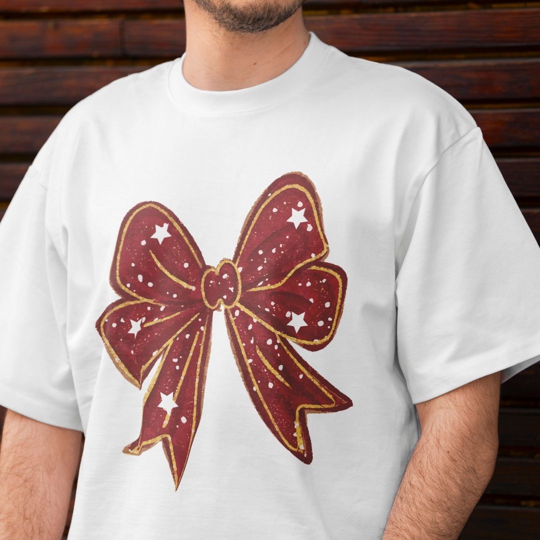 White t-shirt with a large red bow graphic on a wooden background
