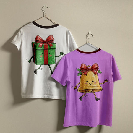 Two children's ringer t-shirts hanging on hangers against a plain beige wall. The left shirt is white with a dark red collar and features a cartoon green gift box graphic on the back.