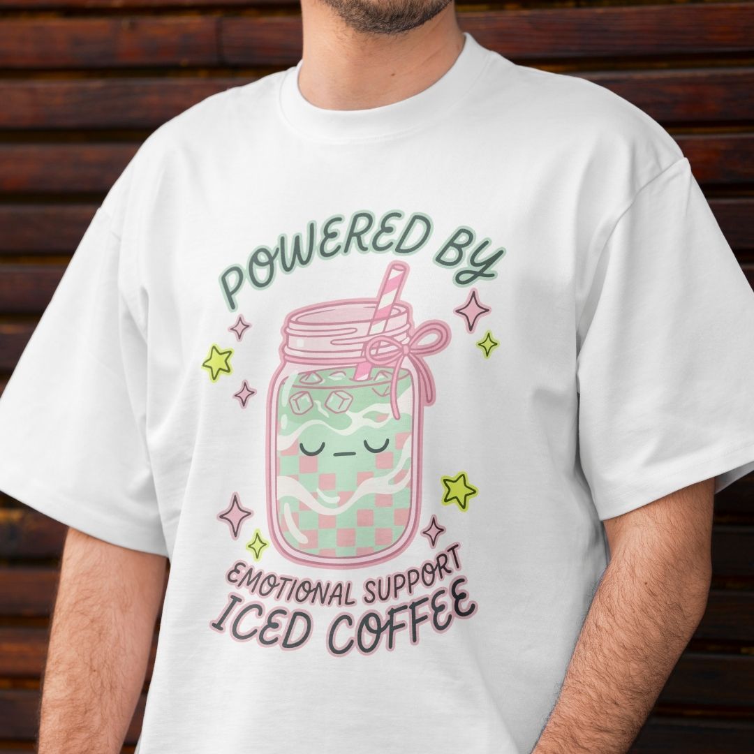 Person wearing a white t-shirt with a colorful design and text.