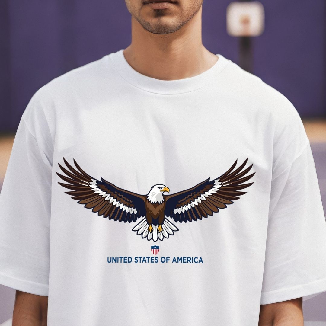 White t-shirt with an eagle design and 'United States of America' text worn by a person.