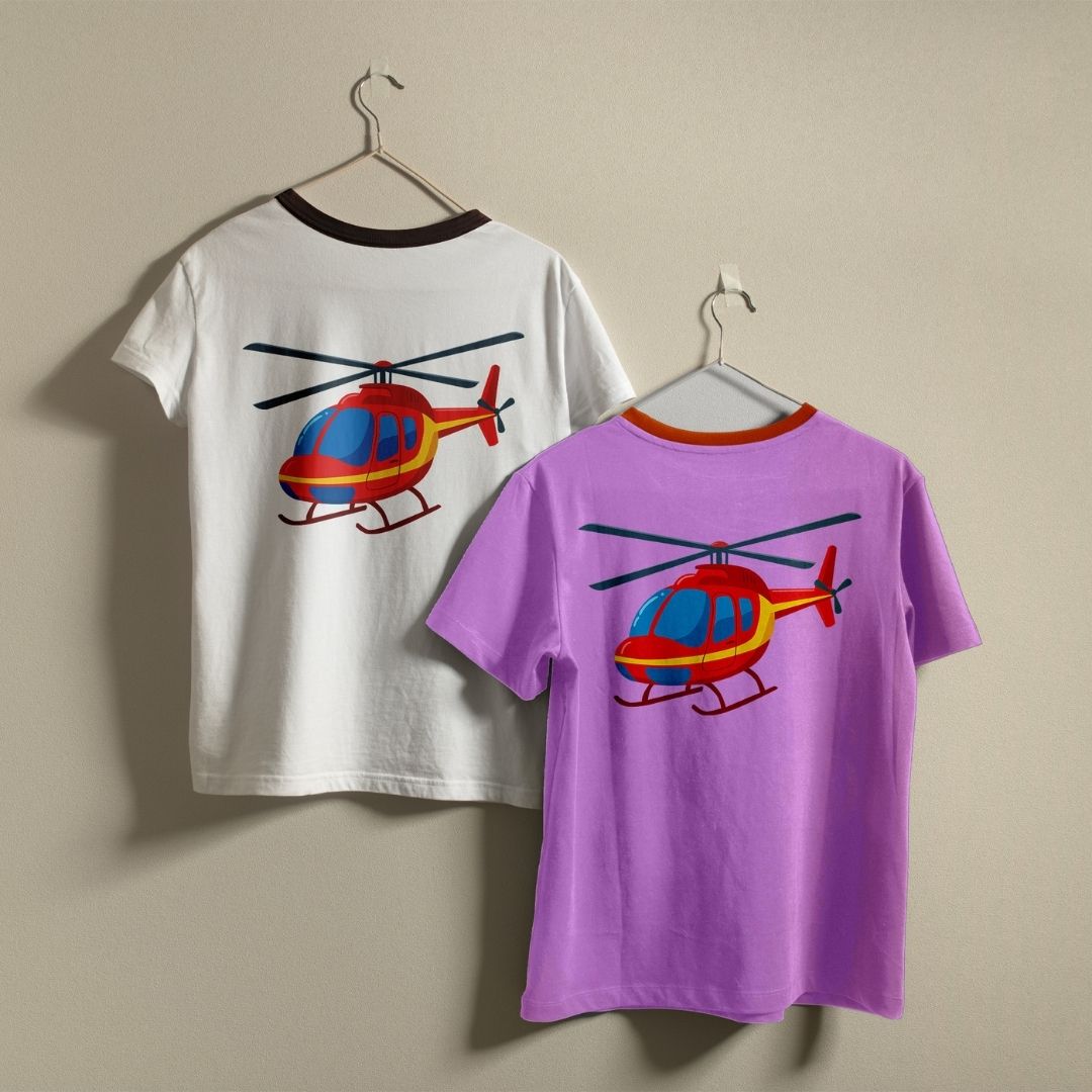 Two short-sleeve T-shirts hanging on hangers against a plain beige wall. The back of a white T-shirt and the front of a lavender purple T-shirt, both featuring a colorful red and yellow helicopter graphic.