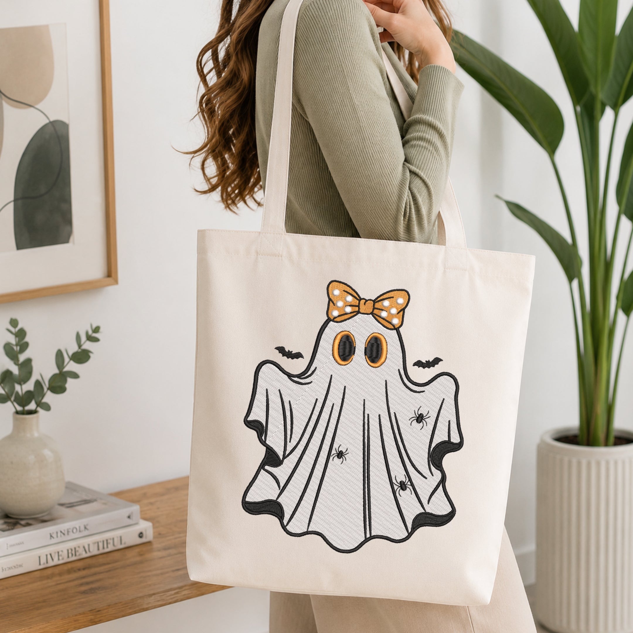 Woman carrying a canvas tote bag decorated with a cute embroidered Halloween ghost.
