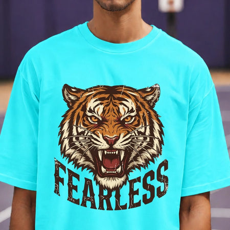 Person wearing a turquoise t-shirt with a tiger graphic and 'FEARLESS' text.