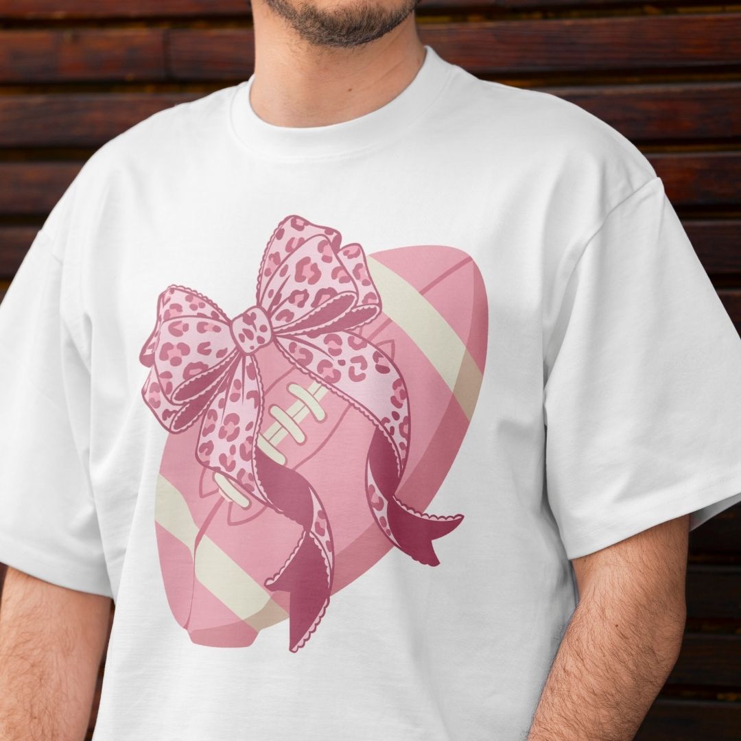 White t-shirt with a pink football and leopard print bow design.