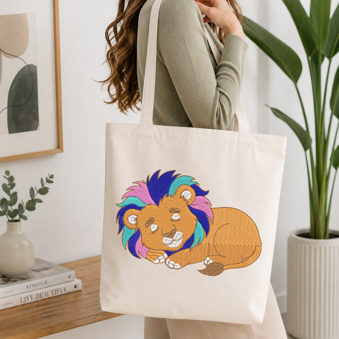 Person holding a tote bag with a colorful lion design in a home setting.