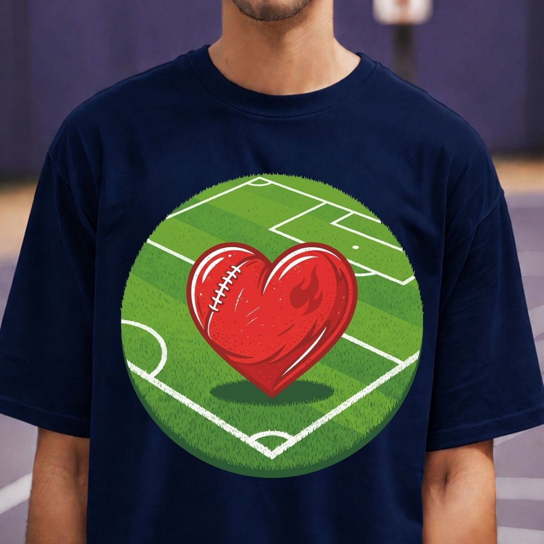 Navy blue t-shirt with a red heart and football design on a green field background.