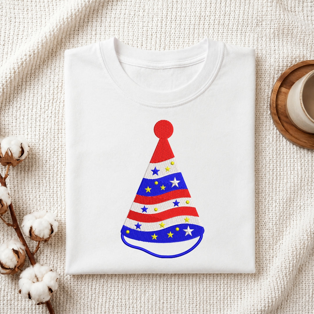 Folded white t-shirt mockup with a red, white, and blue striped party hat embroidery design.
