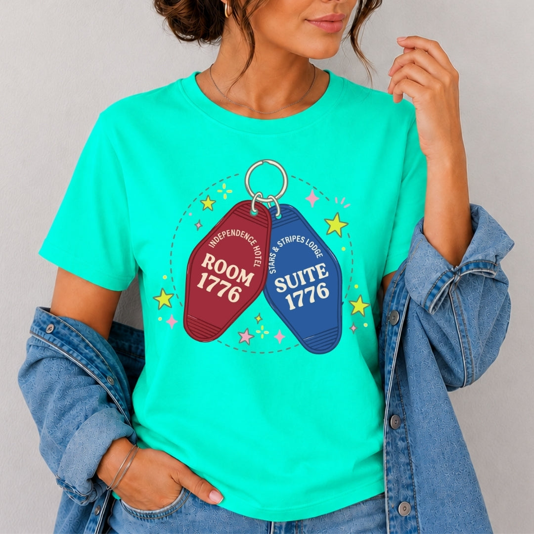 Person wearing a teal t-shirt with motel keychain graphic