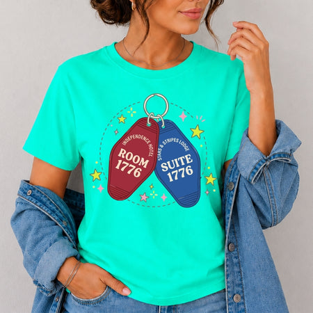 Person wearing a teal t-shirt with motel keychain graphic