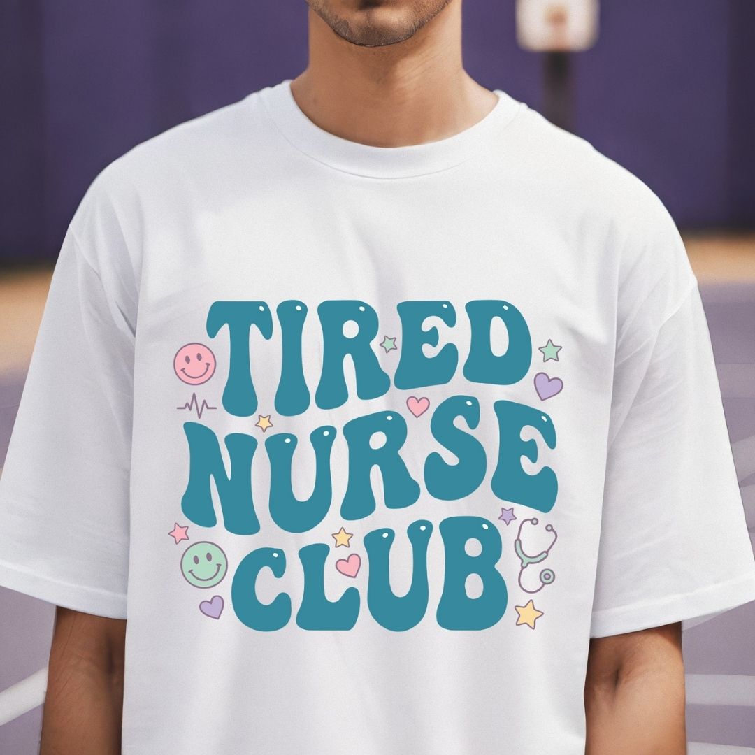 Person wearing a white t-shirt with 'TIRED NURSE CLUB' text and graphics.