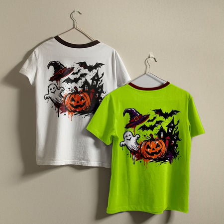 Two children's ringer t-shirts with a Halloween graphic print, displayed on hangers against a plain beige wall. One shirt is white and the other is neon lime green, both featuring a dark red collar trim and a graphic of a jack-o'-lantern, ghosts, a witch's hat, and bats.