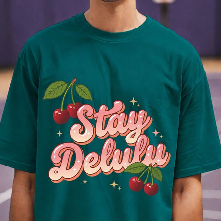 Person wearing a teal t-shirt with 'Stay Deluliu' text and cherries design.