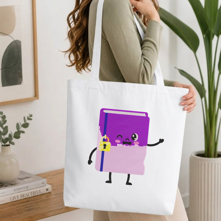 Woman carrying a white natural canvas tote bag featuring an embroidered kawaii notebook design in a bright, modern interior setting.