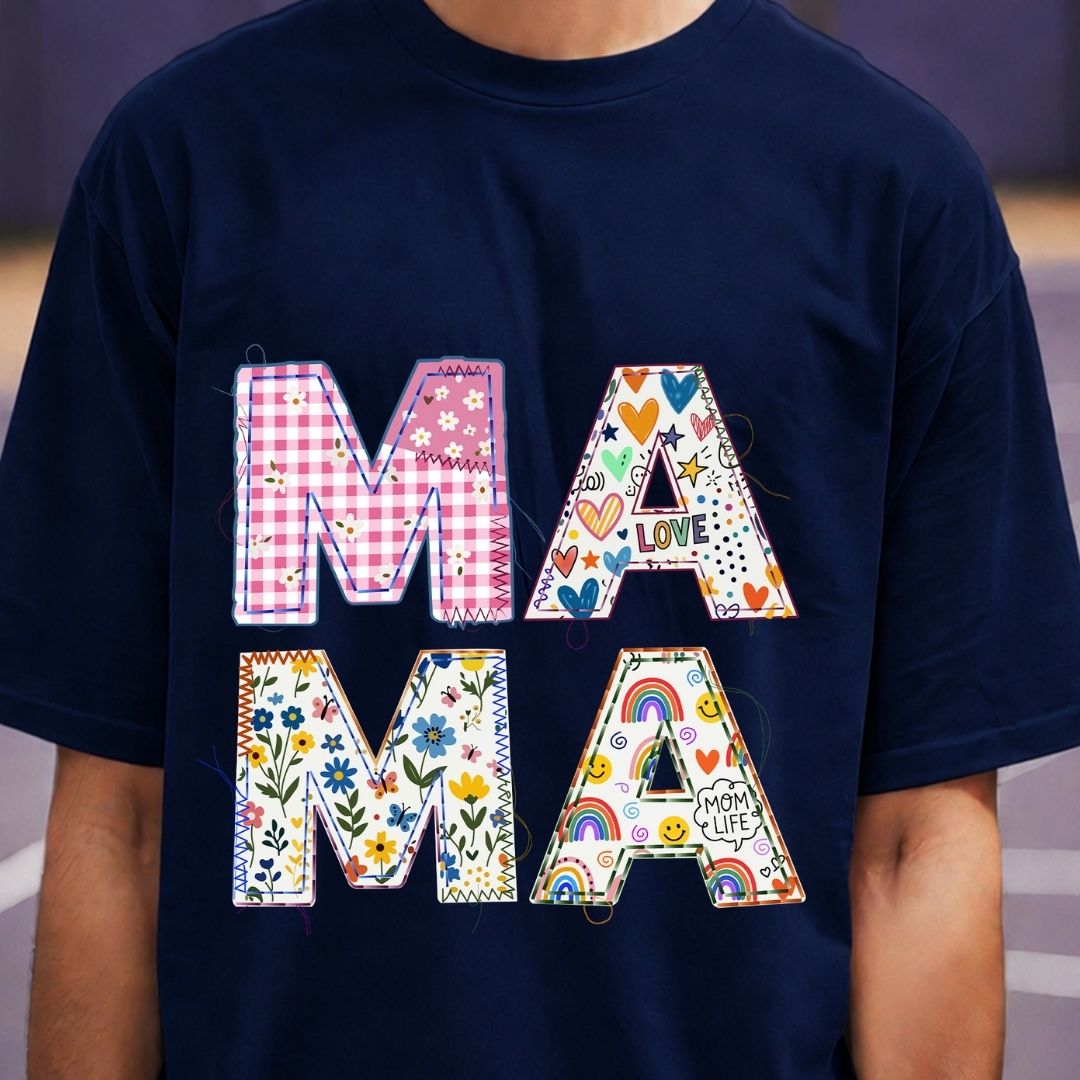Navy blue t-shirt with colorful 'MAMA' text design on a blurred background