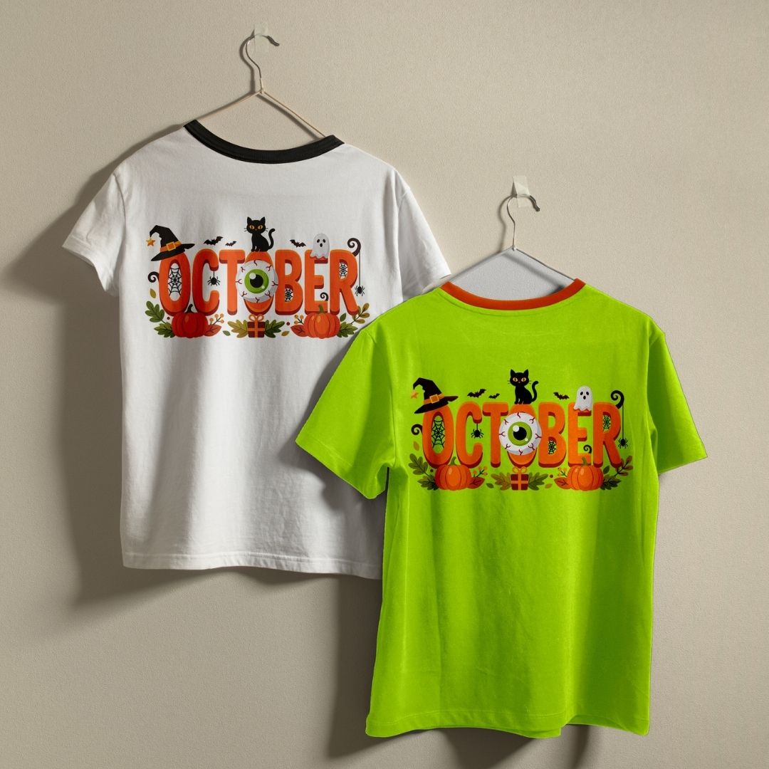 Two crewneck t-shirts in white and neon green hanging on a wall, both featuring a spooky "October" Halloween graphic.