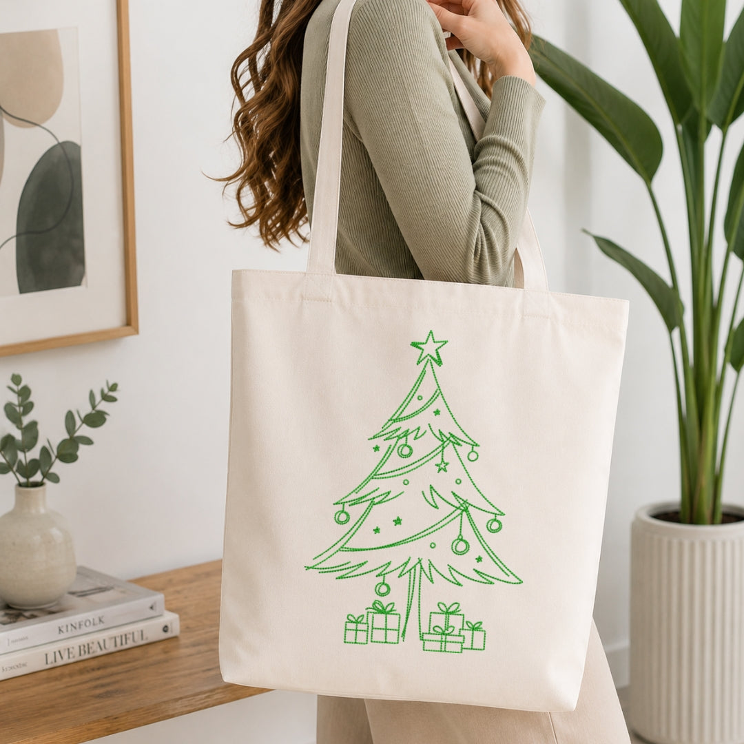 A person holding a cream-colored canvas tote bag featuring the embroidered "Sip, Relax, Repeat" coffee design.