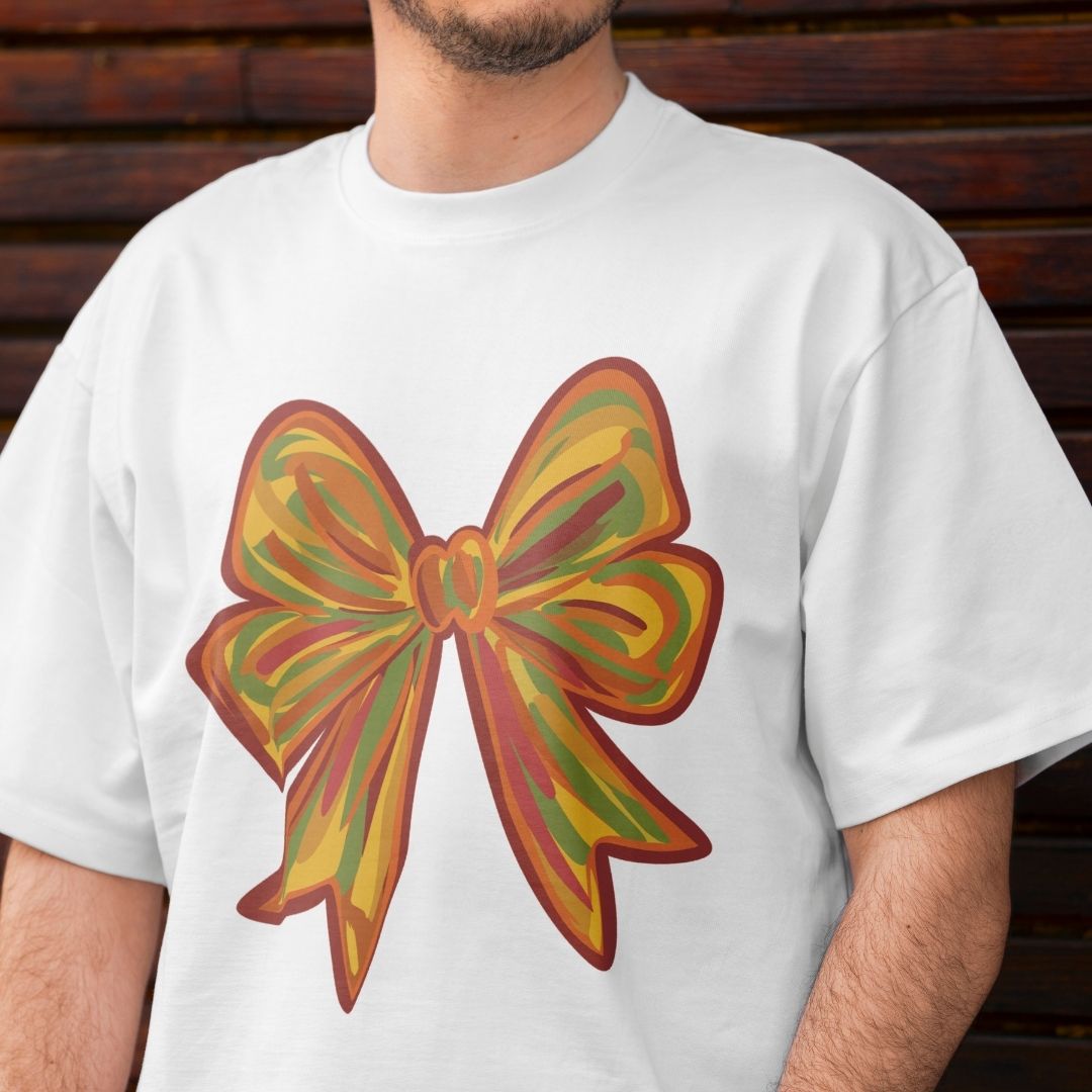 White t-shirt with a colorful bow design worn by a person against a wooden background