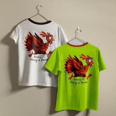 Two ringer t-shirts with a funny cartoon chicken graphic hanging on hangers against a plain beige wall. The left shirt is white with a black collar trim and shows the back graphic.