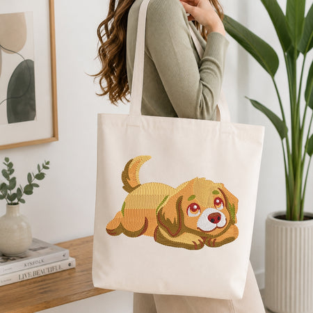 Person holding a tote bag with a dog design in a home setting