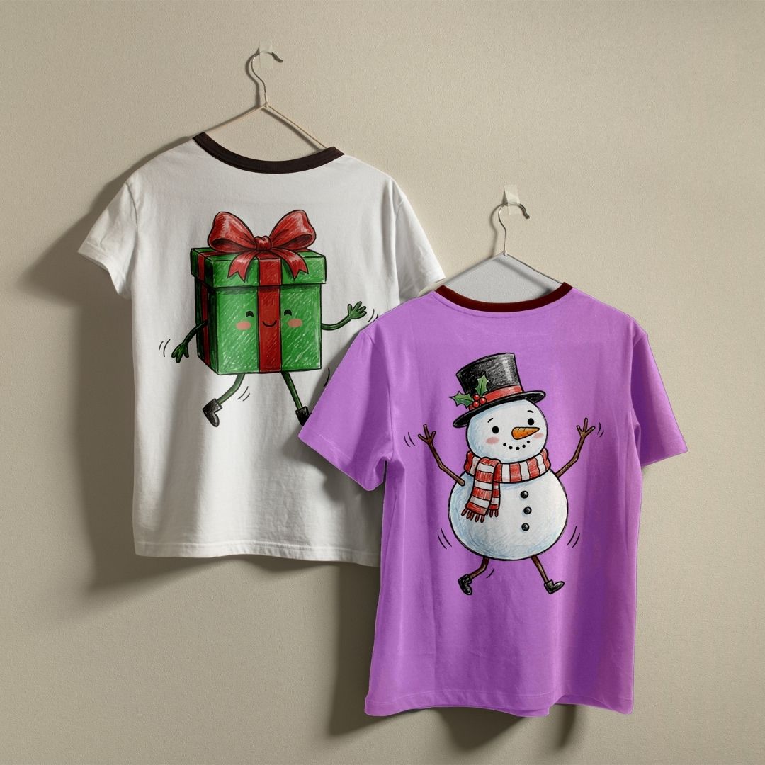 Two children's t-shirts hanging on hangers against a plain beige wall. The left shirt is white with a dark red collar and features a cartoon gift box graphic on the back.