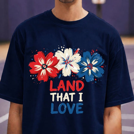 Navy blue t-shirt with red, white, and blue floral design and 'LAND THAT I LOVE' text.