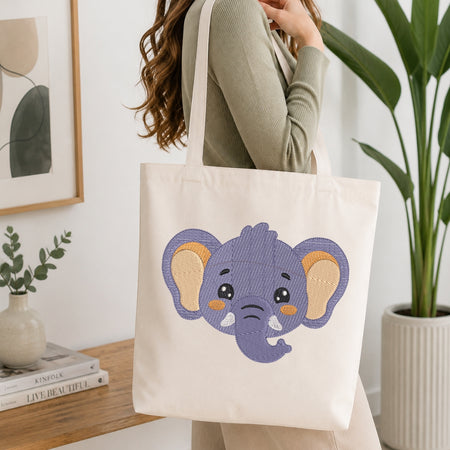 Person holding a tote bag with an elephant design in a home setting.