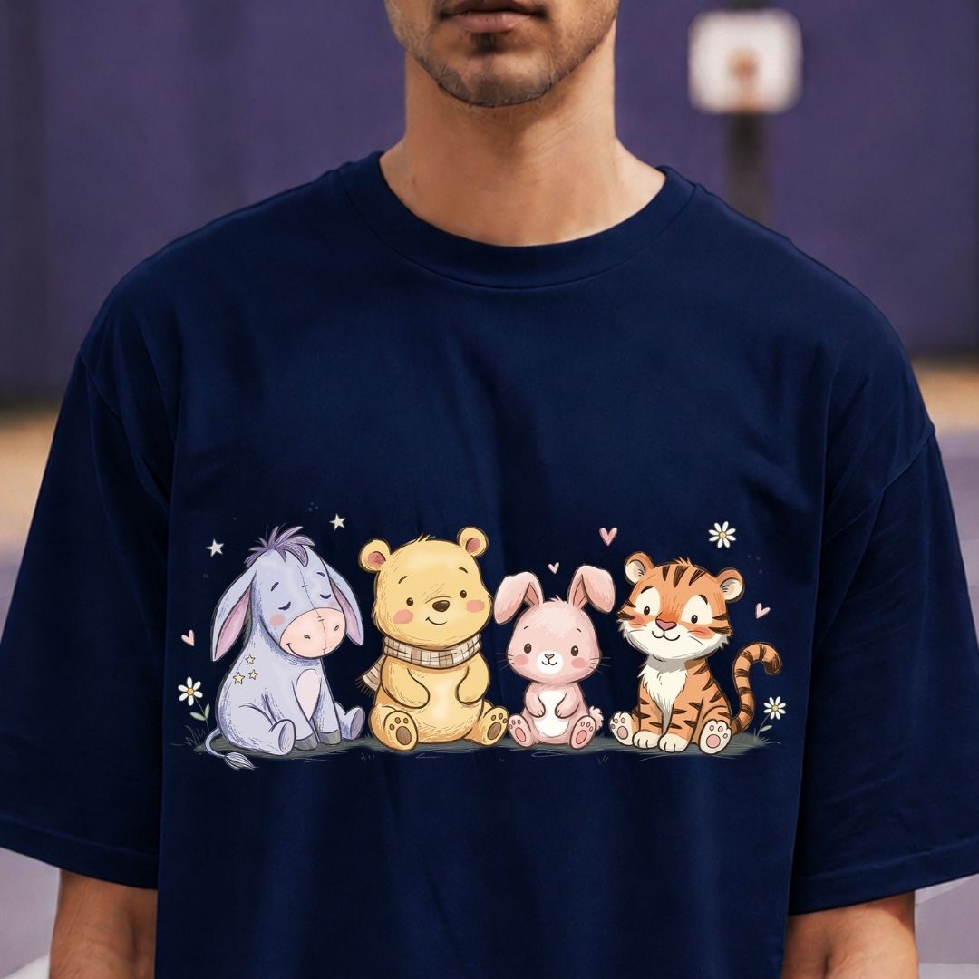Person wearing a navy blue t-shirt with cartoon characters on a blurred background