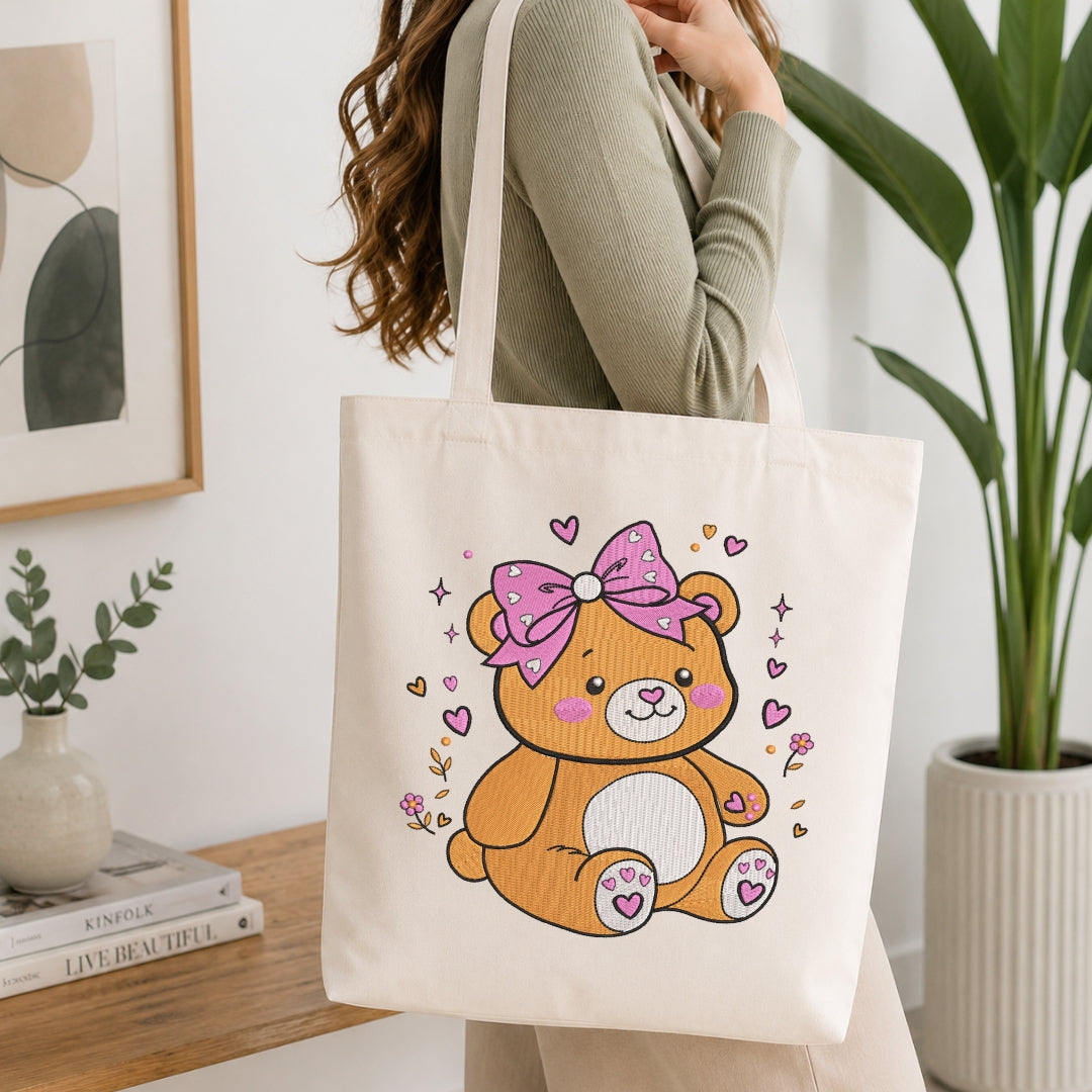 Person carrying a canvas tote bag featuring the stitched teddy bear design.