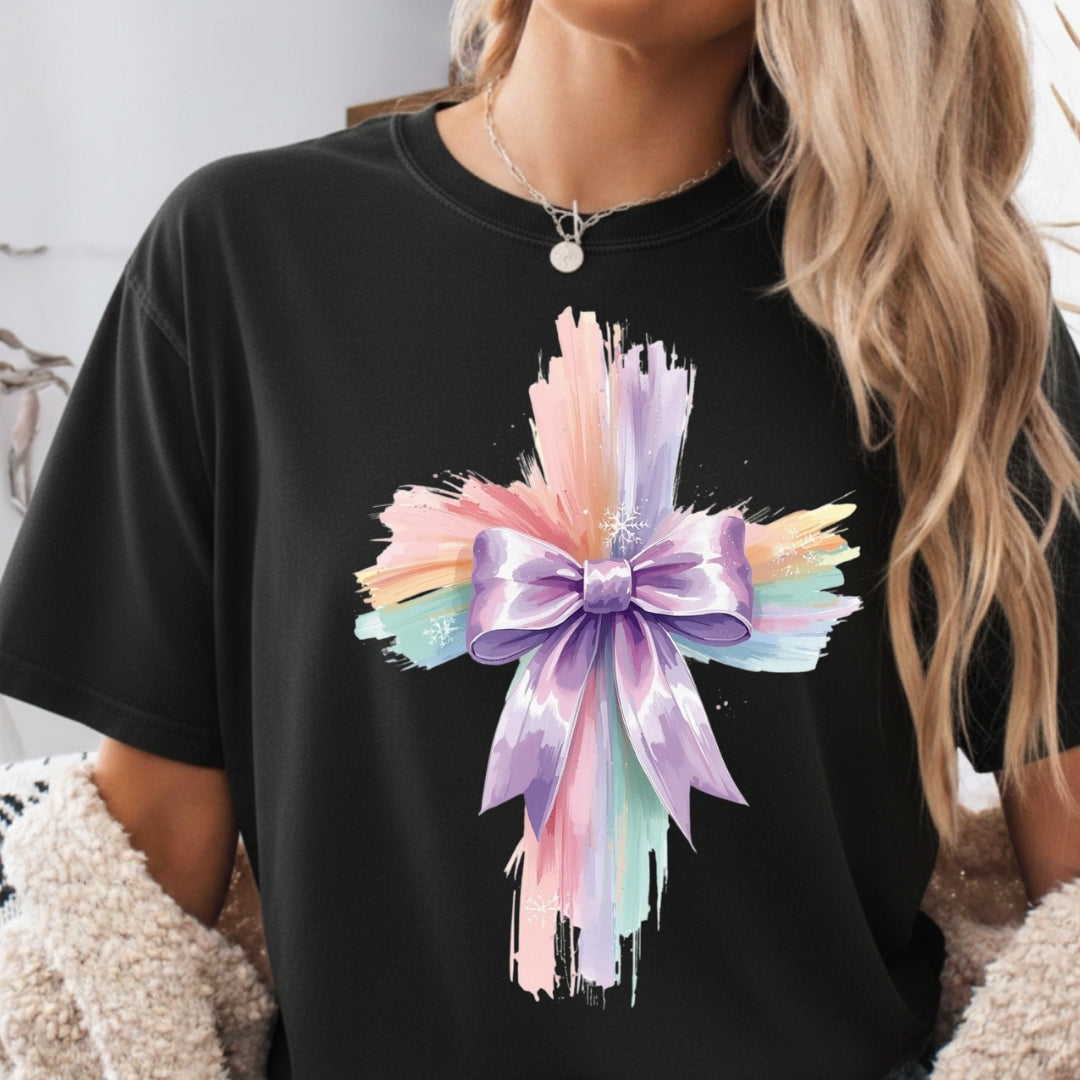 Black t-shirt with a colorful bow design worn by a person.
