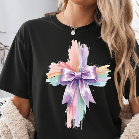 Black t-shirt with a colorful bow design worn by a person.