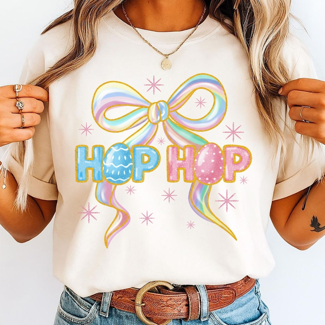 Person wearing a white t-shirt with a colorful bow and 'Hop Hop' text design.