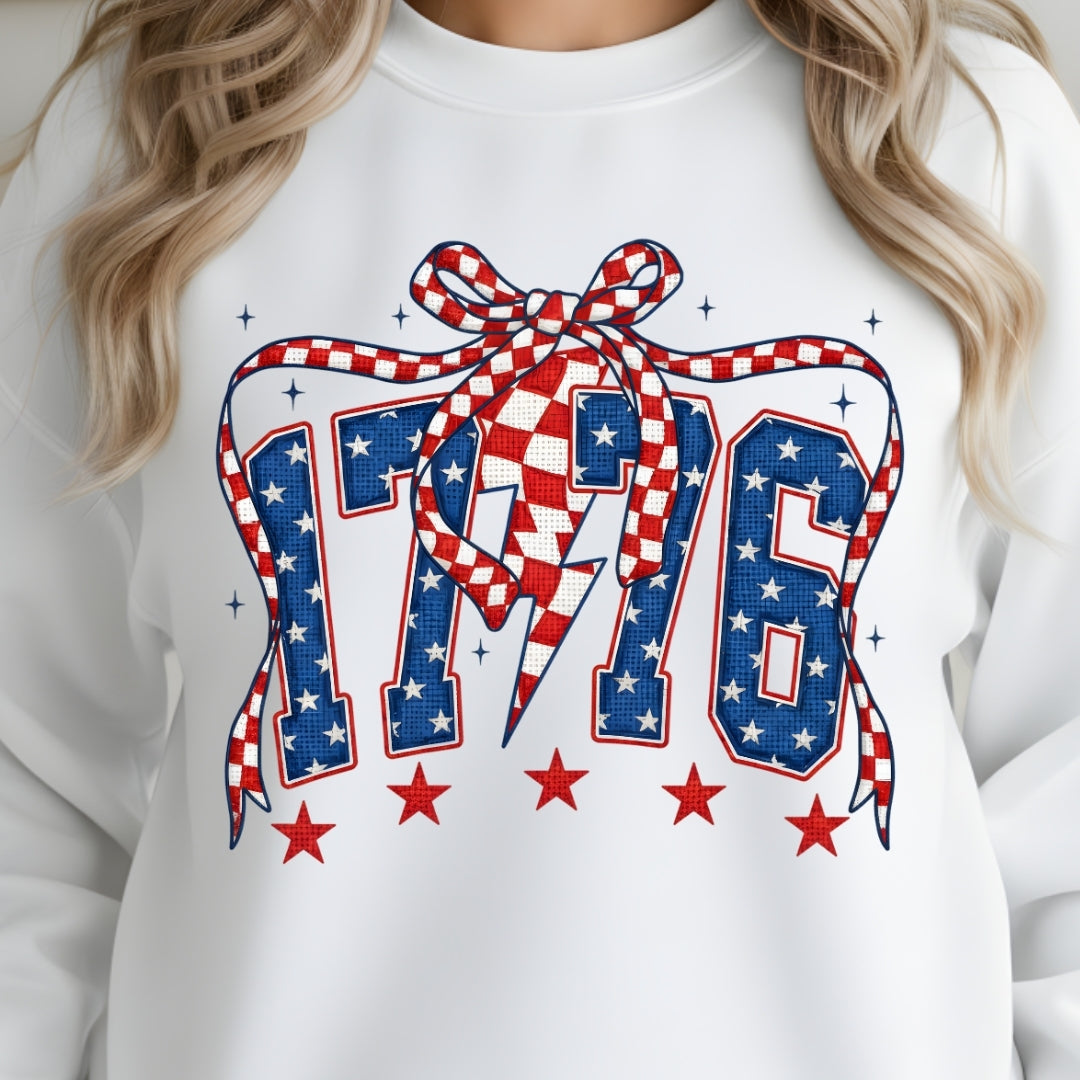 White sweatshirt with '1776' design featuring stars and a checkered ribbon.