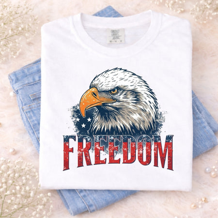 White t-shirt with a bald eagle graphic and 'FREEDOM' text on a light background