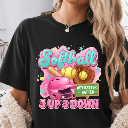 Person wearing a black t-shirt with a colorful softball-themed graphic design.