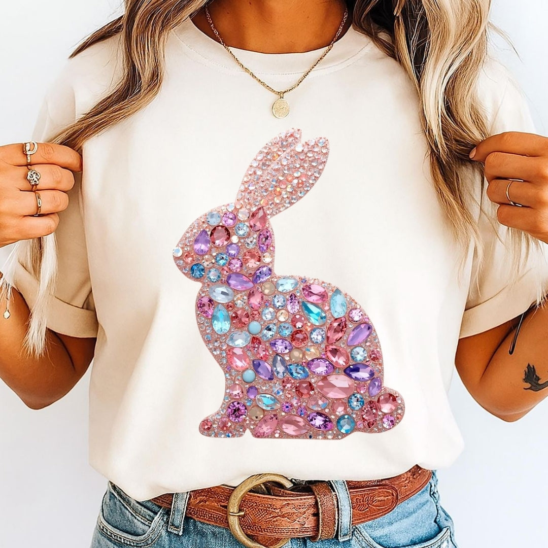 White t-shirt with a decorative rabbit design made of colorful crystals, worn by a person.