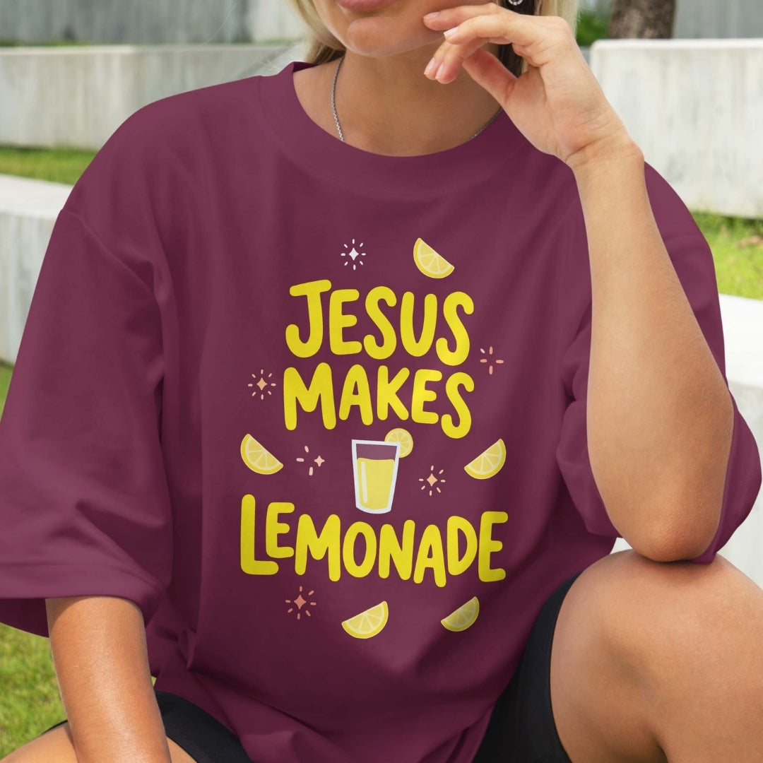 Person wearing a purple t-shirt with 'Jesus Makes Lemonade' text and graphics.