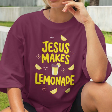 Person wearing a purple t-shirt with 'Jesus Makes Lemonade' text and graphics.